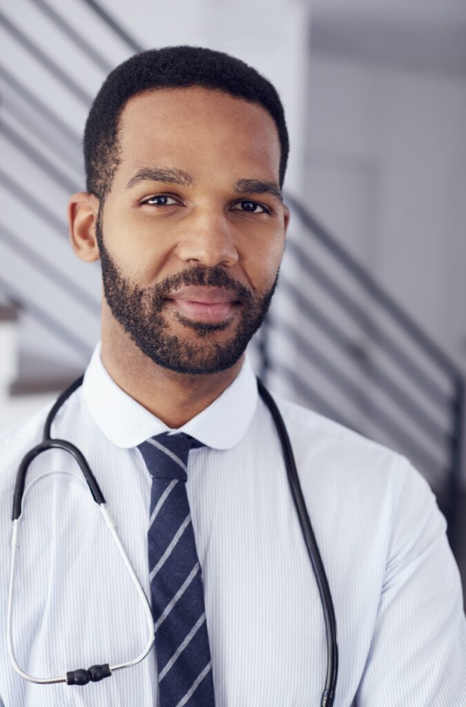 Portrait Of Male Doctor With Stethoscope In Hospital